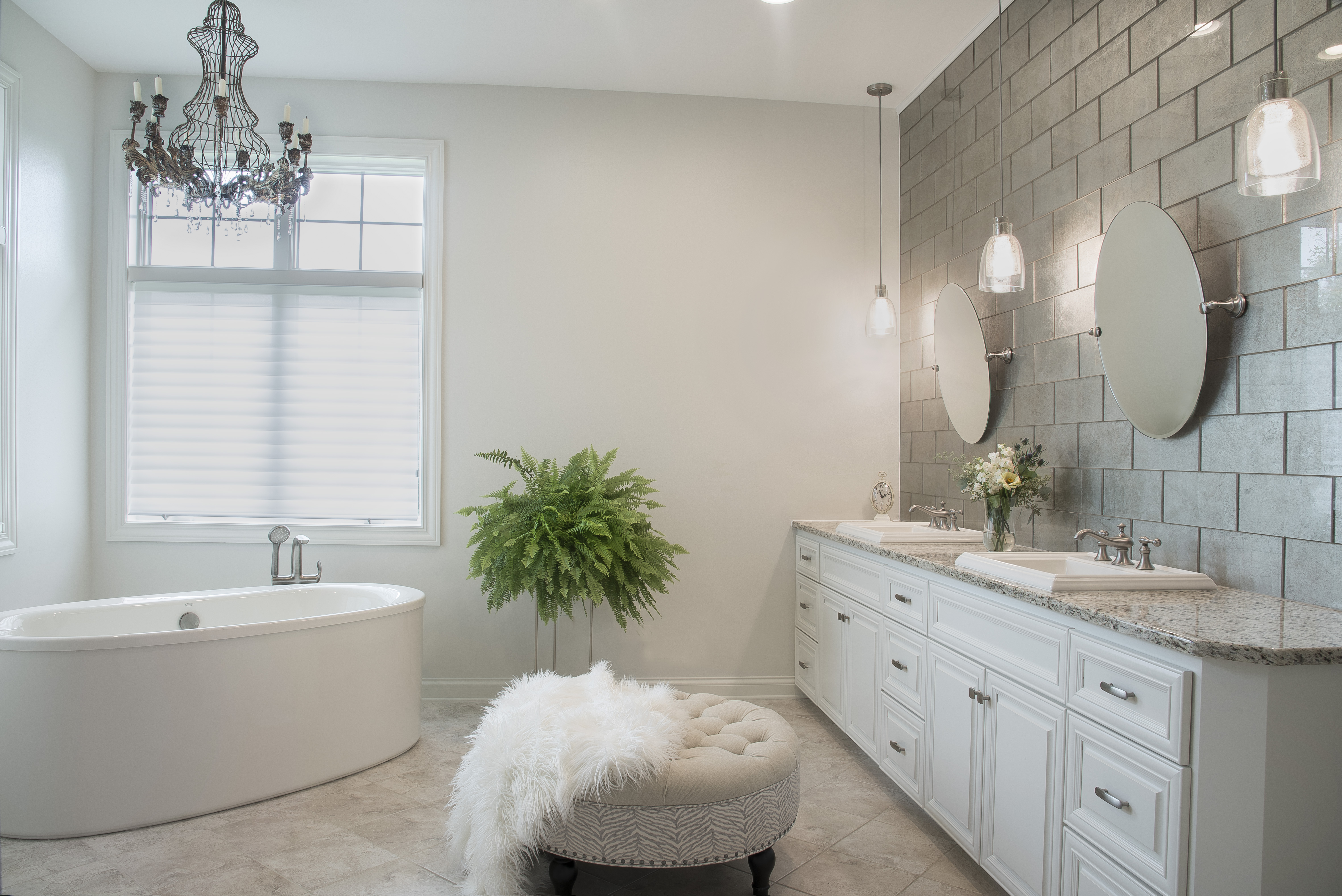 Updated master with contemporary bath tub and chandelier